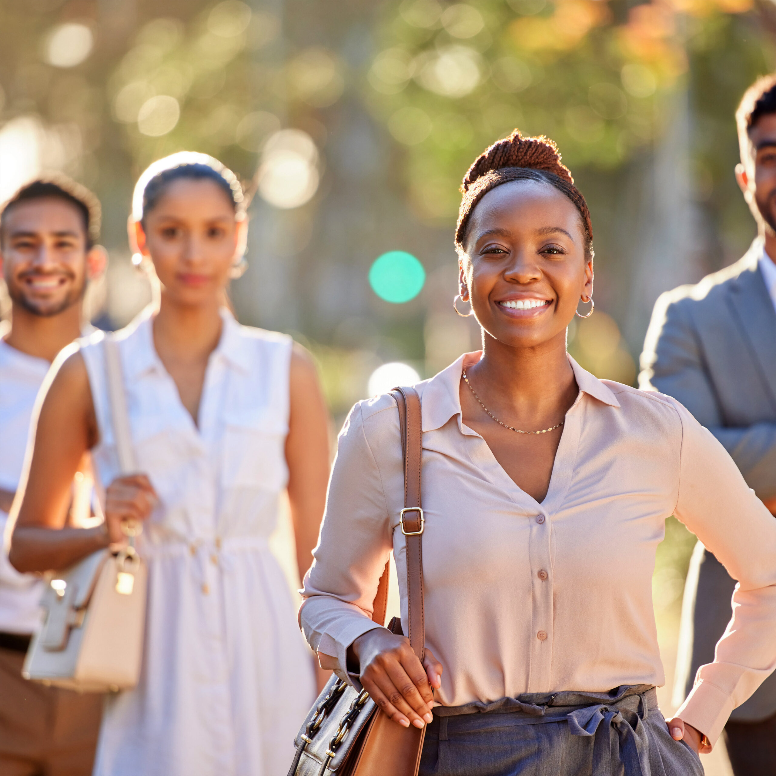 Confident young professionals smiling outdoors, representing Sudsies interns and early career talent.