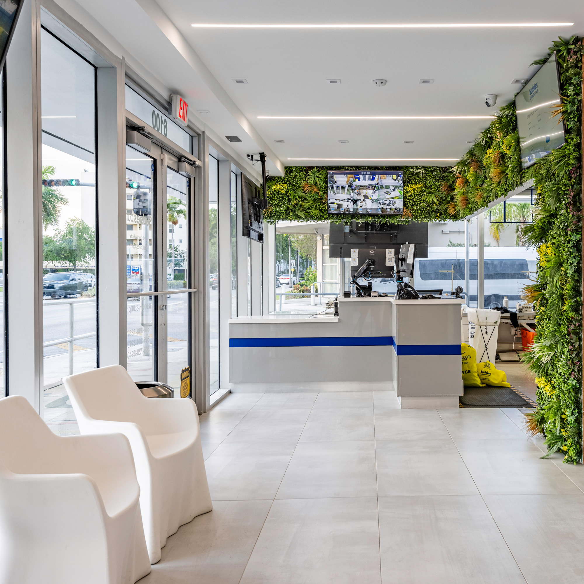 Modern Sudsies Design District boutique interior with sleek counters and living green wall