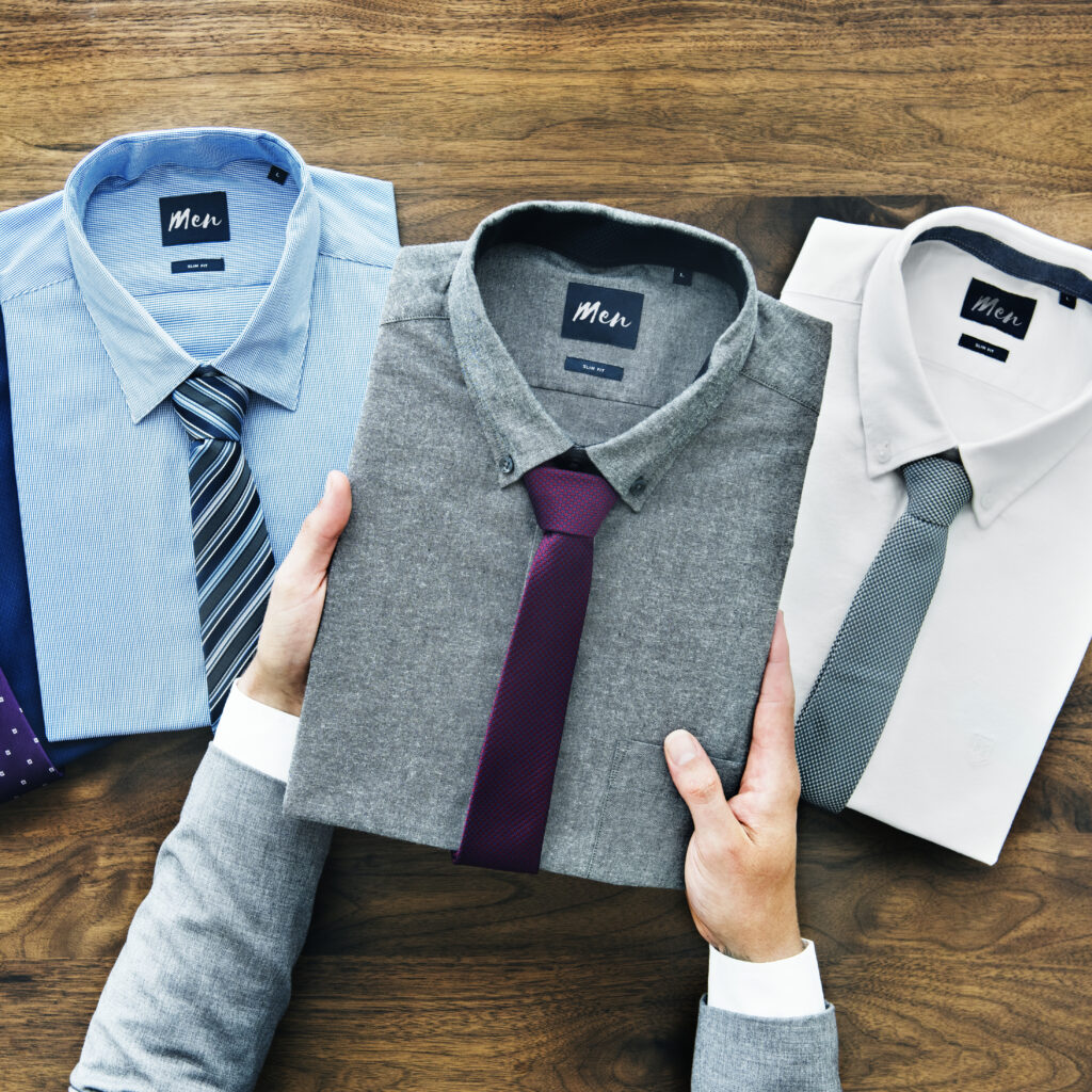 Luxury dress shirts folded neatly on table—designer wardrobe dry cleaning essentials