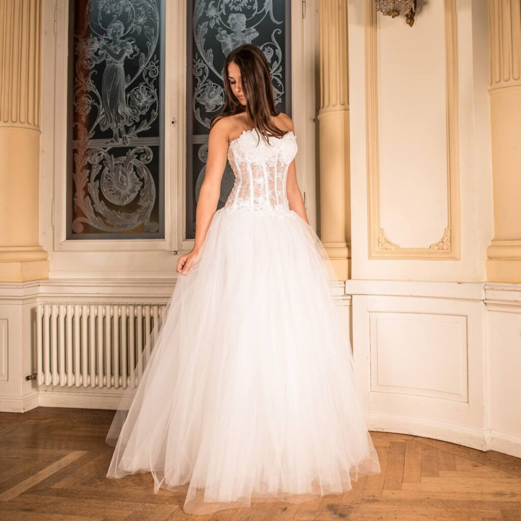 Bride wearing a white wedding dress with lace bodice and full tulle skirt