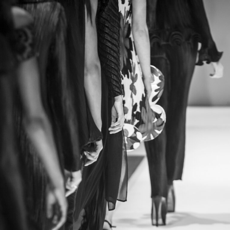 Runway fashion show featuring designer garments in need of specialized dry cleaning