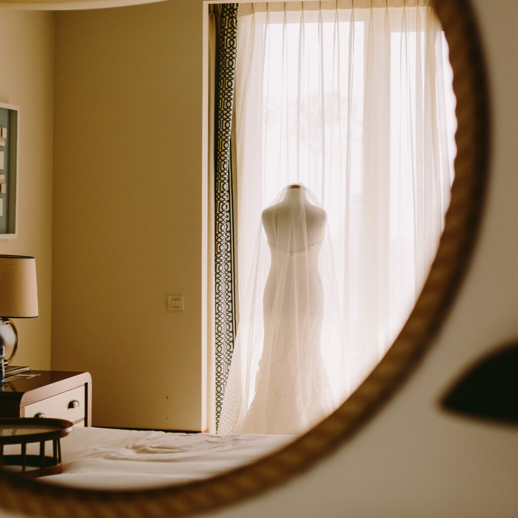 Elegant wedding gown on mannequin by sunlit window at Miami bridal suite