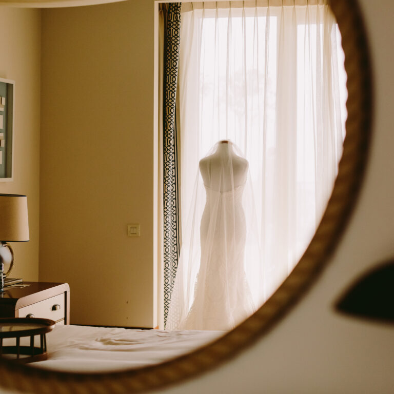 Elegant wedding gown on mannequin by sunlit window at Miami bridal suite