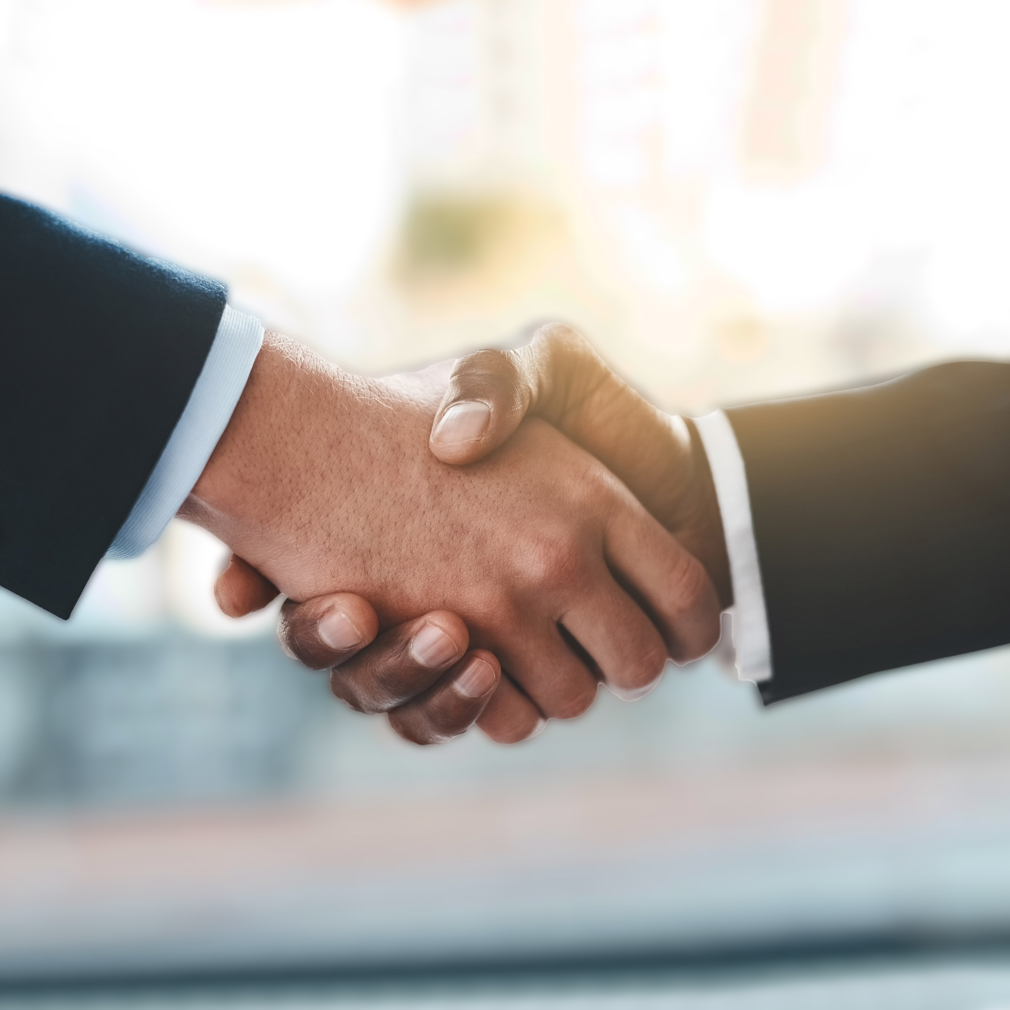 Two professionals shaking hands in a business setting