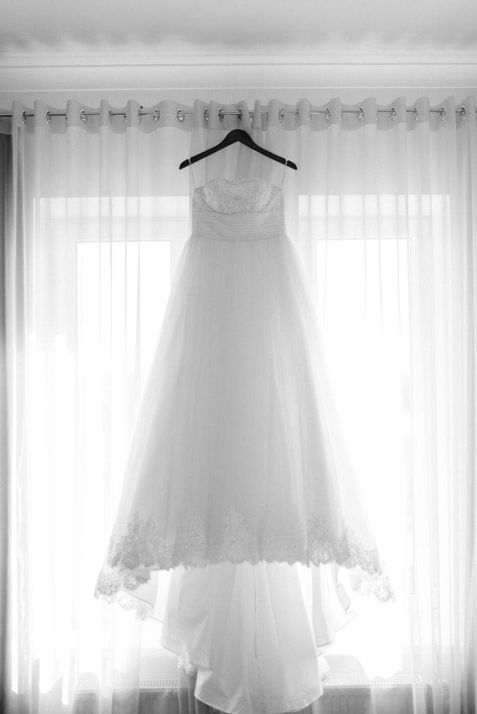 Wedding dress hangs in the window