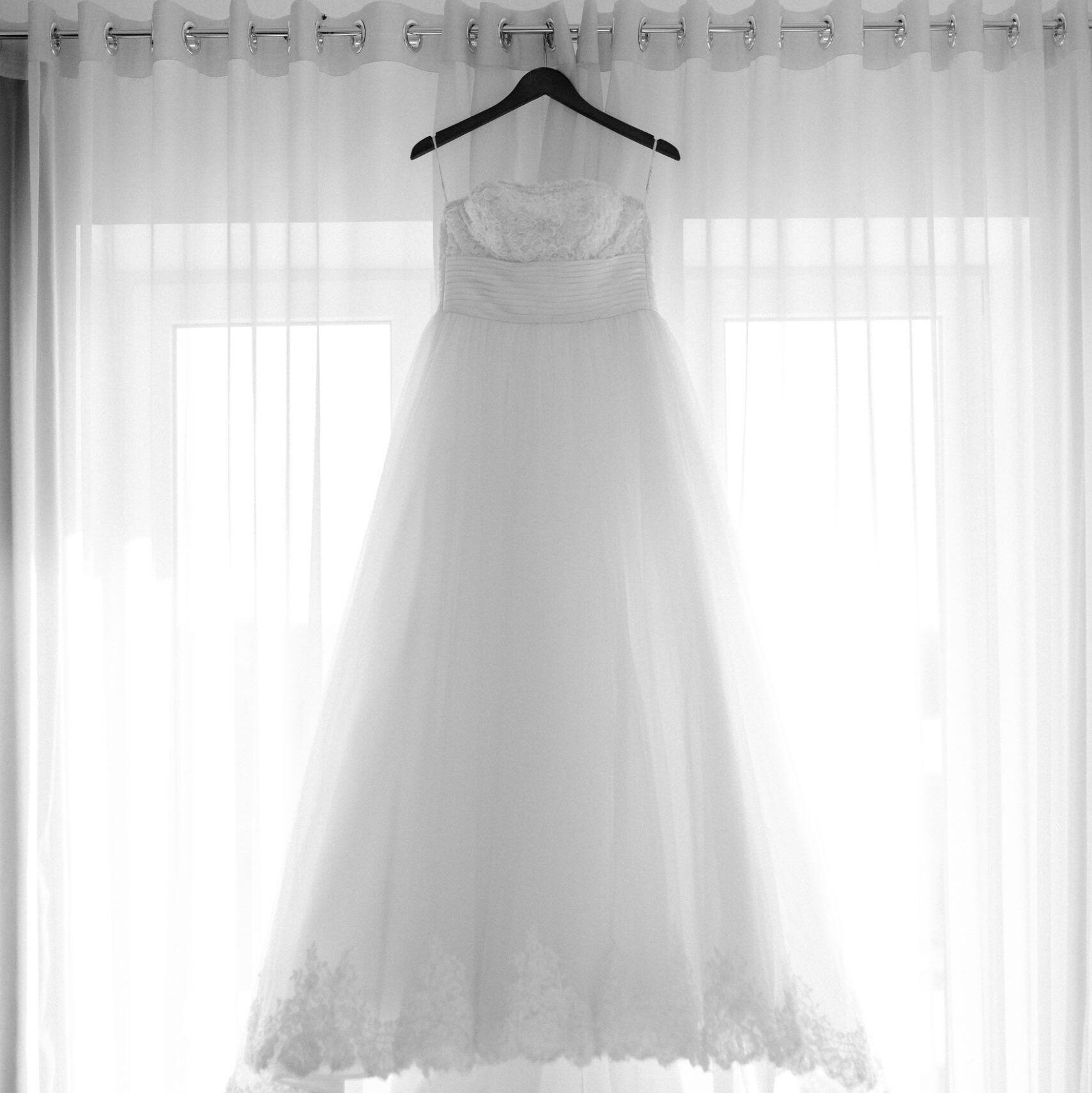 Wedding dress hangs in the window