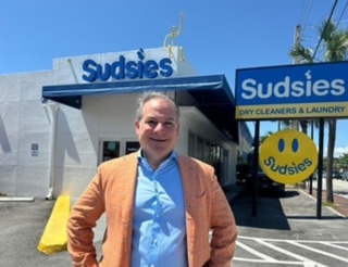 Jason Loeb, man, stands in front of Sudsies dry cleaning business.