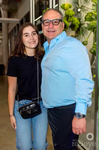 Woman stands with her father.