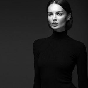 Woman in a black turtleneck representing couture garment care elegance