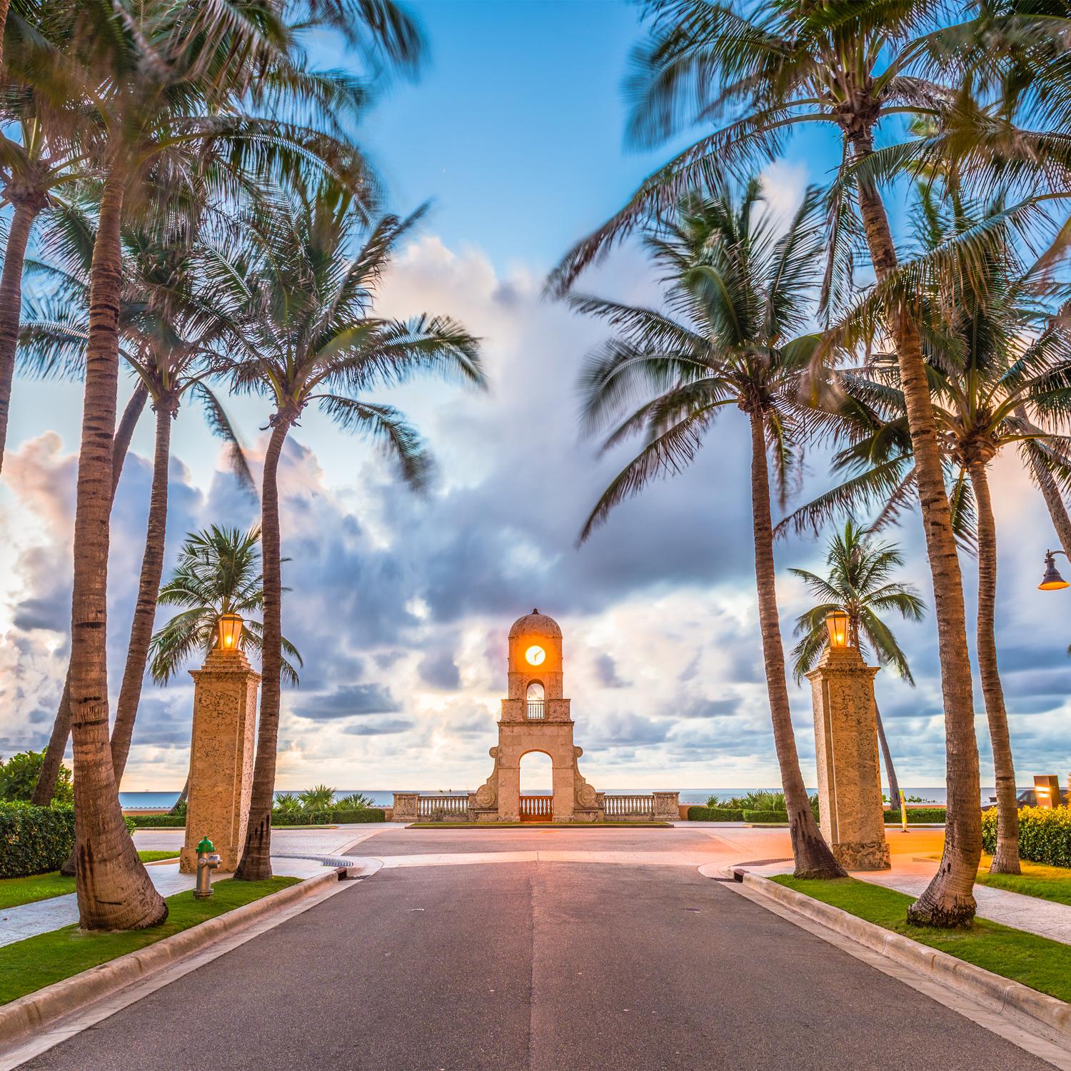 Palm-lined entrance to Worth Avenue in Boca Raton at sunrise