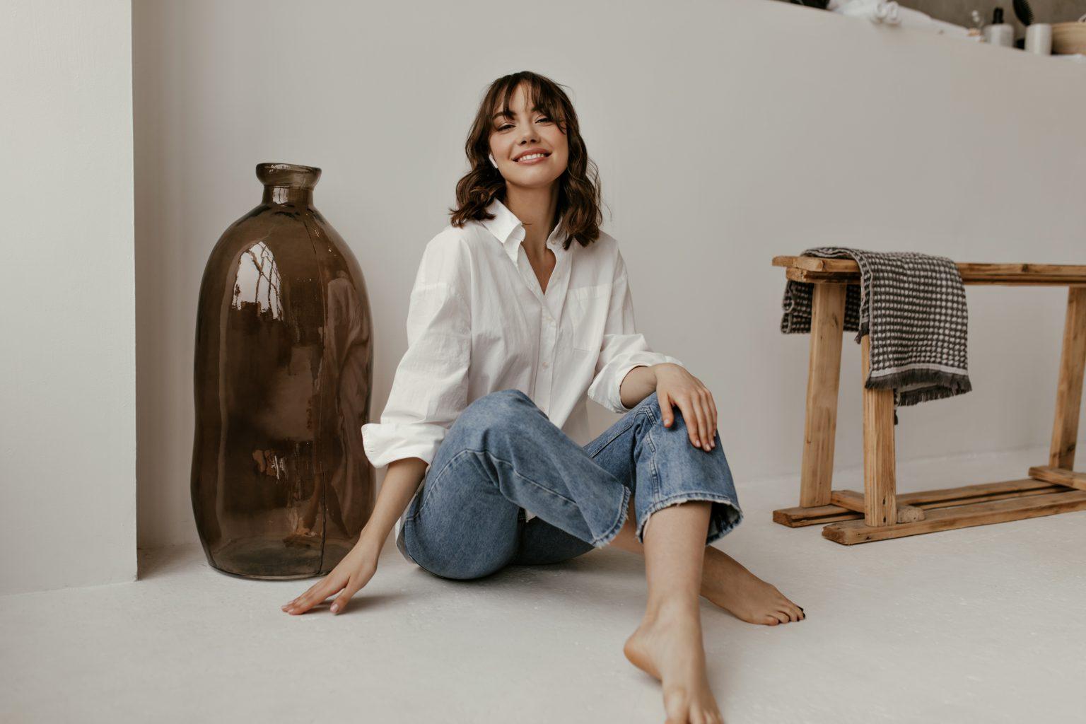 Woman smiling in casual attire, representing relaxed and stress-free living with Sudsies.