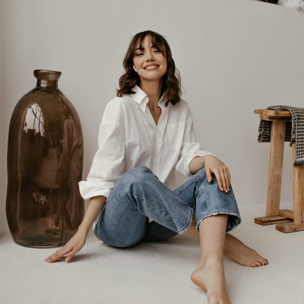 Woman smiling in casual attire, representing relaxed and stress-free living with Sudsies.