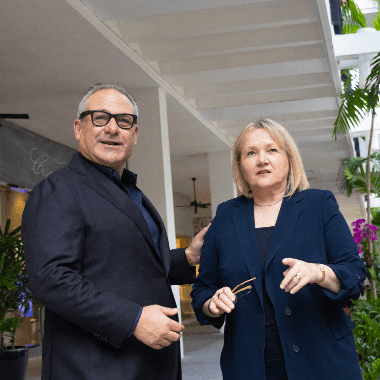 Meiloute Marquez of Akris and Jason Loeb of Sudsies share a moment celebrating two decades of luxury guest care.