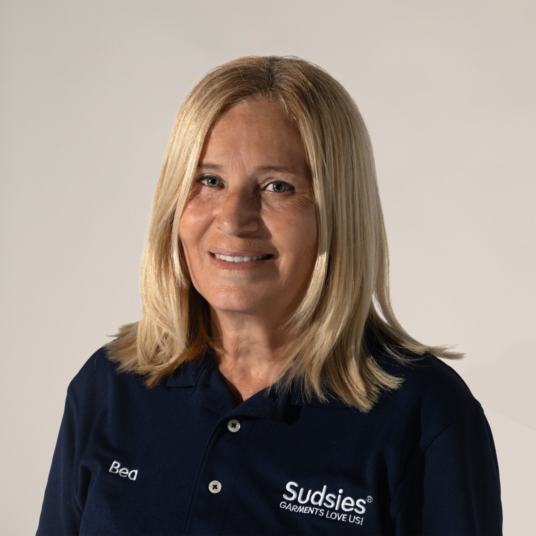 Beatriz Daszynsky, Operations Manager at Sudsies, smiling in company uniform