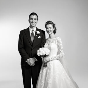 Vintage-inspired wedding portrait highlighting a lace gown, connected to heirloom preservation of century-old garments.