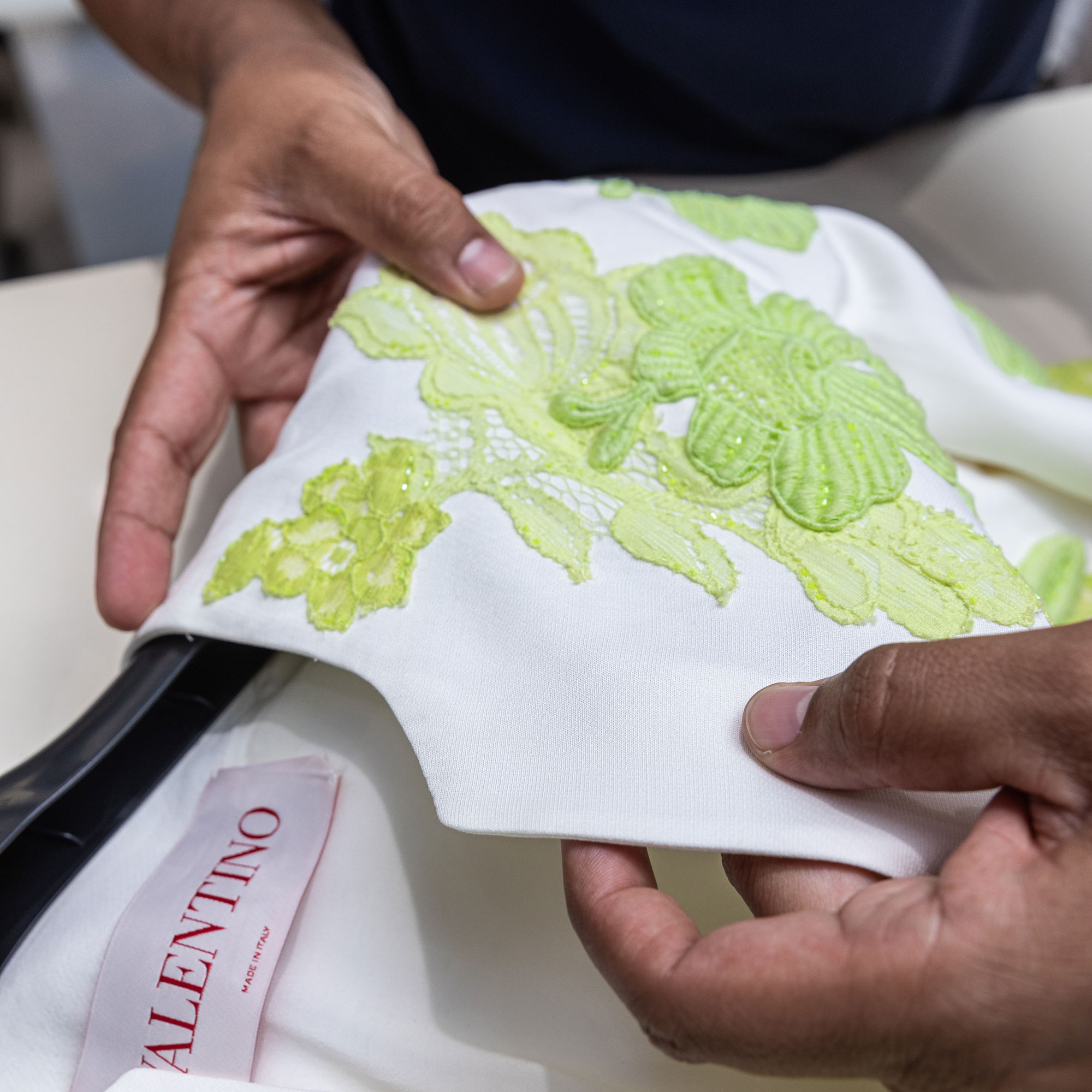 Delicate designer garment with detailed embroidery carefully handled by Sudsies Dry Cleaners