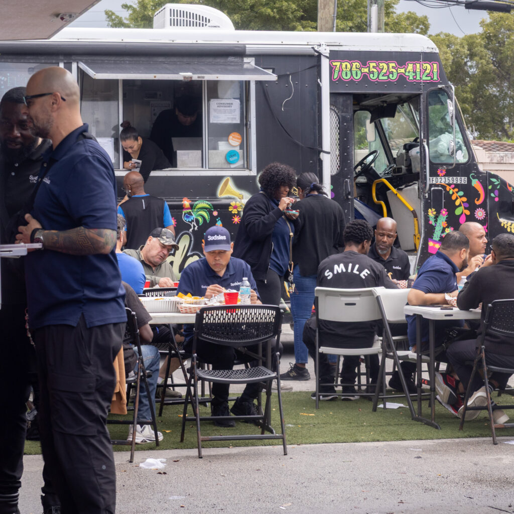 Sudsies Dry Cleaners team enjoying a community food truck event together