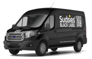 Sudsies Black Label delivery van with luxury garment care branding on vehicle