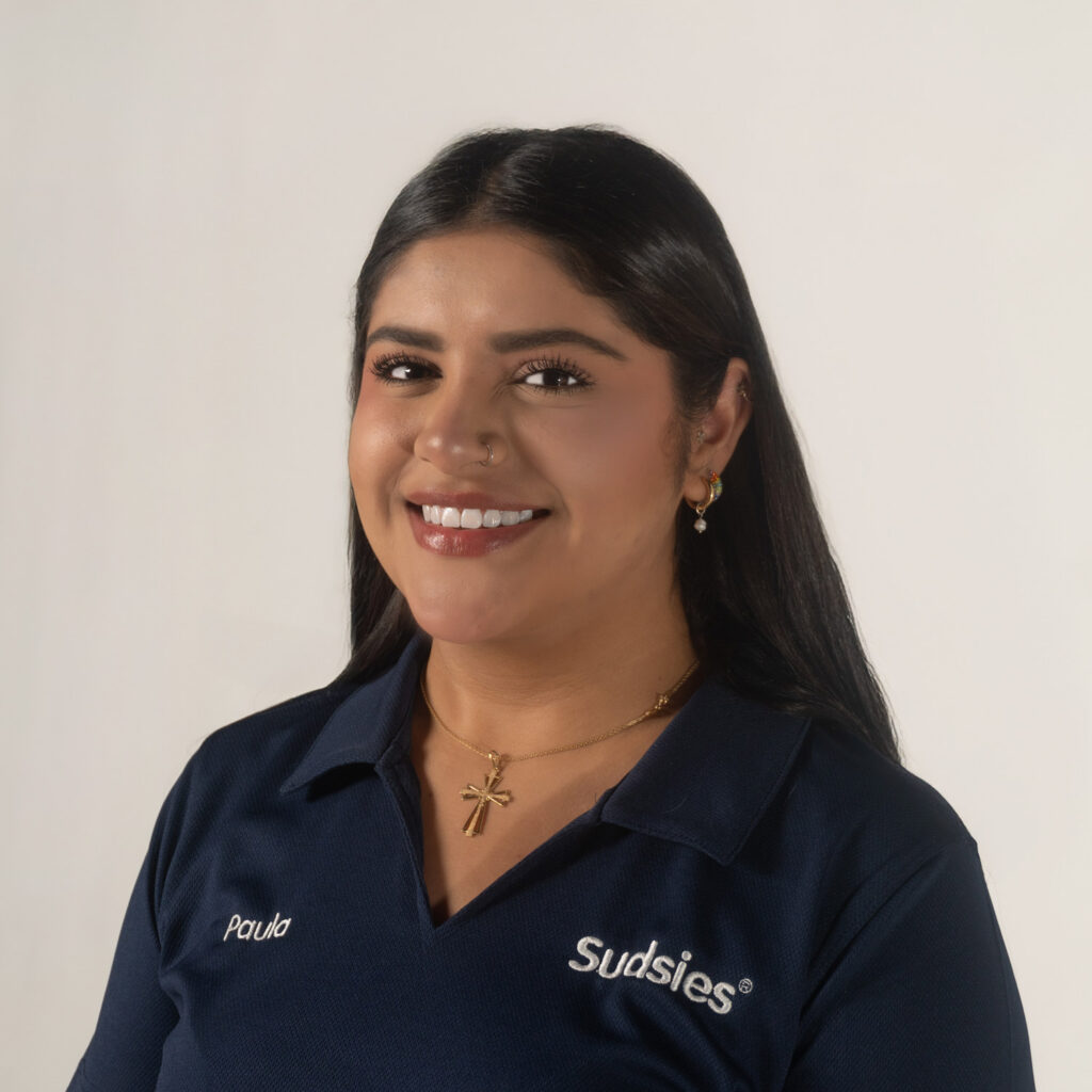 Paula Sudsies garment care valet wearing navy uniform smiling portrait