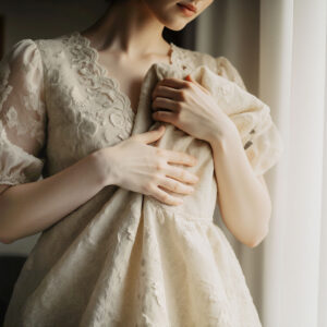 Delicate lace garment held carefully to highlight luxury fabric care and preservation