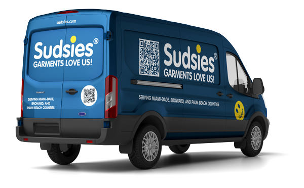 Blue Sudsies delivery van with logos and QR code, advertising garment cleaning services for Miami-Dade, Broward, and Palm Beach counties
