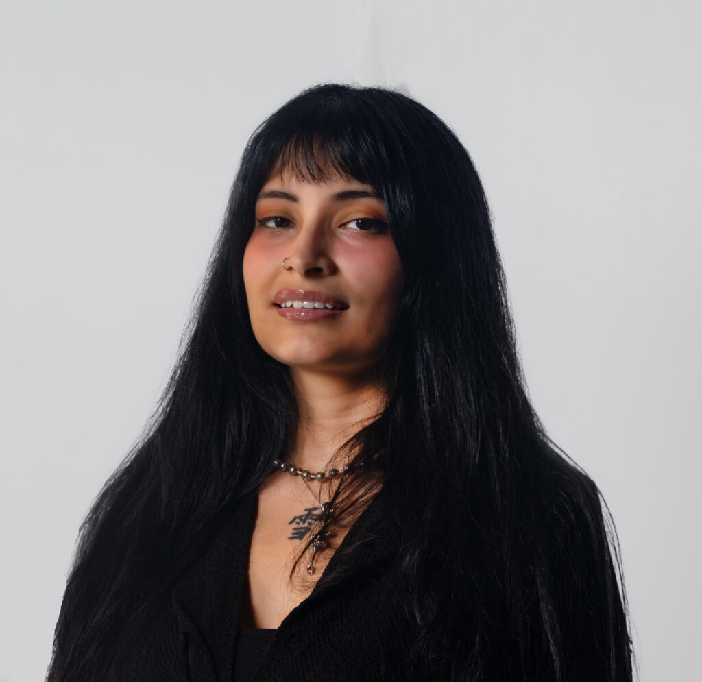 Portrait of Oyuky Martinez, UI/UX Designer at Sudsies, photographed in a studio setting.